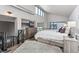 Bright main bedroom with high ceilings, a large window, a comfortable bed, and wood-look floors throughout at 3100 Huron St # 4Q, Denver, CO 80202