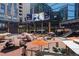 Spacious outdoor plaza with lively seating, vibrant umbrellas, and large screens for entertainment at 3100 Huron St # 4Q, Denver, CO 80202