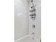 Close-up of a clean, bright shower with white tile, modern fixtures, and a convenient shower caddy at 3100 Huron St # 4Q, Denver, CO 80202