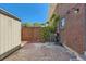 Spacious backyard with brick exterior, wood fence and stone patio at 9263 E Nassau Ave, Denver, CO 80237