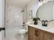Bright bathroom featuring marble tile, updated fixtures, and a modern vanity at 9263 E Nassau Ave, Denver, CO 80237