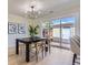 A dining area includes a table, chairs, modern lighting, and a sliding glass door at 9263 E Nassau Ave, Denver, CO 80237