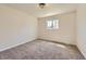 Empty bedroom with carpet and a window letting in natural light at 9263 E Nassau Ave, Denver, CO 80237