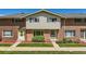 Charming brick townhome with a well-maintained front yard and a welcoming entrance at 9263 E Nassau Ave, Denver, CO 80237
