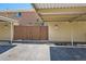 Parking area with carport and wooden fence at 9263 E Nassau Ave, Denver, CO 80237