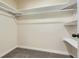 Empty walk-in closet with carpet and shelving at 9263 E Nassau Ave, Denver, CO 80237
