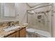 Bathroom showcasing a vanity, sink, granite countertop, shower with glass door, and neutral tile at 4195 W 111Th Cir, Westminster, CO 80031