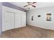 Bedroom featuring neutral walls, carpet, closet with sliding doors, windows, and ceiling fan at 4195 W 111Th Cir, Westminster, CO 80031