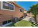 Home exterior with a small yard, window well, and central air conditioning unit at 4195 W 111Th Cir, Westminster, CO 80031