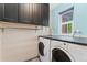 Laundry room with newer appliances, overhead cabinets, a bright window, and great lighting at 4195 W 111Th Cir, Westminster, CO 80031