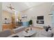 Bright living room with a fireplace, fan, skylight and open access to the kitchen at 4195 W 111Th Cir, Westminster, CO 80031
