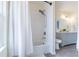 Bathroom featuring a shower/tub with a white tile surround, a gray vanity, and modern fixtures at 4653 S Yank St, Morrison, CO 80465