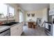 Bright dining area with a rustic wooden table, ample natural light, and access to the backyard at 4653 S Yank St, Morrison, CO 80465