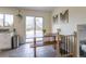 Bright dining area with a wooden table, slider door, and stylish decor at 4653 S Yank St, Morrison, CO 80465