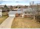 Charming two-story home featuring a brick facade, attached garage, and beautiful mountain views at 4653 S Yank St, Morrison, CO 80465