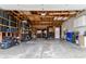 Spacious garage with exposed ceiling and shelving offering ample storage and workspace at 4653 S Yank St, Morrison, CO 80465