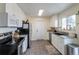 Functional kitchen featuring white cabinetry, stainless steel appliances, and a window at 4653 S Yank St, Morrison, CO 80465