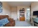 This sitting room features a comfortable sofa, a bookshelf, and a doorway leading to another room at 4653 S Yank St, Morrison, CO 80465