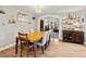 Dining room features an open archway, wooden table, stylish decor, and a glimpse into a comfortable living space at 1123 E 132Nd Way, Thornton, CO 80241