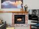 Charming brick fireplace with a decorative mantel, creating a cozy focal point in a comfortable living space at 1123 E 132Nd Way, Thornton, CO 80241