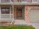 Charming front entrance with brick accents, covered porch, and well-maintained landscaping at 1123 E 132Nd Way, Thornton, CO 80241