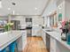 Modern kitchen featuring white cabinets, stainless steel appliances, and granite countertops, brightened by a sunlit window at 1123 E 132Nd Way, Thornton, CO 80241