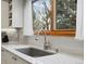Modern kitchen sink with granite countertop, stainless steel appliances, and under cabinet lighting at 1123 E 132Nd Way, Thornton, CO 80241