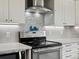 Close up of the stainless steel stove and hood in a newly updated kitchen at 1123 E 132Nd Way, Thornton, CO 80241