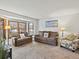 Cozy living room featuring neutral tones, a bay window, and comfortable seating for a relaxing atmosphere at 1123 E 132Nd Way, Thornton, CO 80241