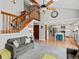 Spacious living room with vaulted ceilings, a grand staircase, open kitchen, and modern furnishings for a comfortable home at 1123 E 132Nd Way, Thornton, CO 80241
