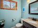 Charming powder room with granite counters, and a stylish framed mirror and window for natural light at 1123 E 132Nd Way, Thornton, CO 80241