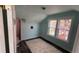 A sunlit bedroom features charming details, a plush rug, and views of blooming trees through the window at 2320 22Nd St, Boulder, CO 80304
