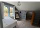 This bedroom features a charming chandelier, unique wood wall texture, and a bright window view at 2320 22Nd St, Boulder, CO 80304