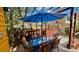 Outdoor wooden deck with colorful patio seating under an umbrella and wooden pergola at 2320 22Nd St, Boulder, CO 80304