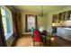 Inviting dining area with hardwood floors, a chandelier, and large windows, seamlessly connecting to the adjacent kitchen at 2320 22Nd St, Boulder, CO 80304