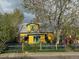 Charming yellow home with a colorful arched entry and unique curb appeal at 2320 22Nd St, Boulder, CO 80304