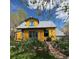 Charming two-story home with a colorful yellow exterior and beautiful landscaping in the front yard at 2320 22Nd St, Boulder, CO 80304