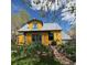 Charming yellow home with unique architectural details and lush front yard landscaping at 2320 22Nd St, Boulder, CO 80304
