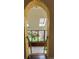Arched entry to a sunroom with patterned tile floors, multiple windows, skylights, and lush indoor plants at 2320 22Nd St, Boulder, CO 80304