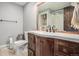 Classic bathroom with wood vanity, tile floors, and a shower-tub combo at 14753 E Alabama Pl, Aurora, CO 80012