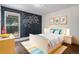 Bright bedroom with playful decor, laminate floors and a large window at 14753 E Alabama Pl, Aurora, CO 80012
