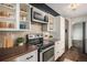 Modern kitchen featuring stainless steel appliances, wooden countertops and white cabinets at 14753 E Alabama Pl, Aurora, CO 80012