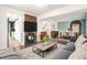 Cozy living room featuring a fireplace, modern furnishings, and an open floor plan at 14753 E Alabama Pl, Aurora, CO 80012