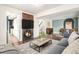 Inviting living room featuring a fireplace, hardwood floors, and an open floor plan, creating a warm and stylish space at 14753 E Alabama Pl, Aurora, CO 80012