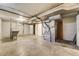 The basement is unfinished with a furnace, laundry sink and storage at 2285 N Monaco Pkwy, Denver, CO 80207