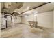 Unfinished basement features open space, vintage sink, and utility components at 2285 N Monaco Pkwy, Denver, CO 80207