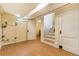 This basement offers vinyl floors, a staircase, and natural light at 2285 N Monaco Pkwy, Denver, CO 80207