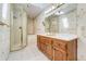 Bright bathroom with walk-in shower, vanity, and floral wallpaper at 2285 N Monaco Pkwy, Denver, CO 80207