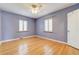 Cozy bedroom featuring light purple walls and refinished hardwood floors at 2285 N Monaco Pkwy, Denver, CO 80207