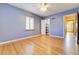 Bedroom featuring light purple walls, refinished hardwood floors, and closet at 2285 N Monaco Pkwy, Denver, CO 80207